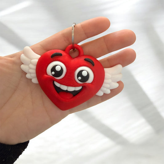 Llavero corazon feliz con alas impreso en 3D detalle cara Bids 3D
